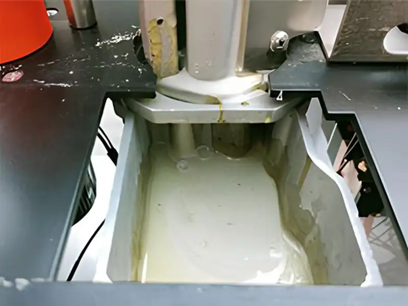 Interior view of the HE-305U heavy duty manual edge bander showing the industrial-grade enlarged hot-melt glue pot with premium black Teflon non-stick coating.