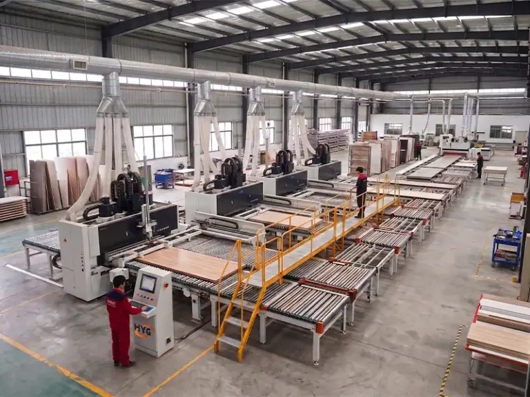 Industrial on-site operation of the HYG custom multi-station CNC six-sided drilling production line, showing automatic panel feeding and heavy-duty boring aggregates.